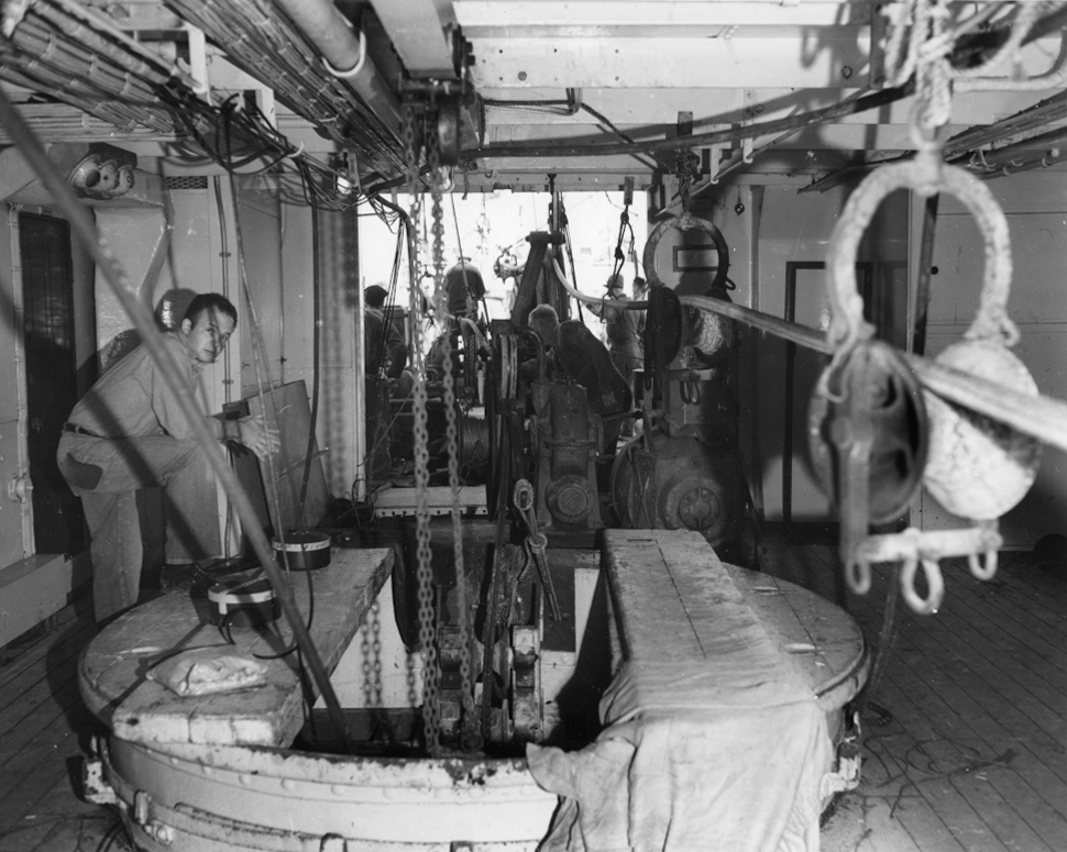 Crew working below deck with the submarine telephone cable.