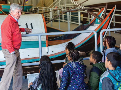 Docent giving a tour to students in the International Small Craft Center.