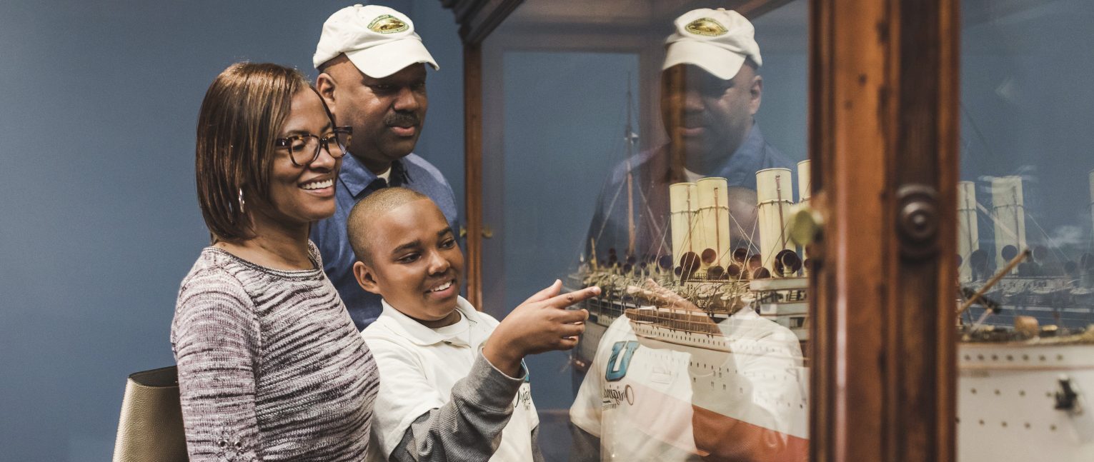 Family looking at a ship model