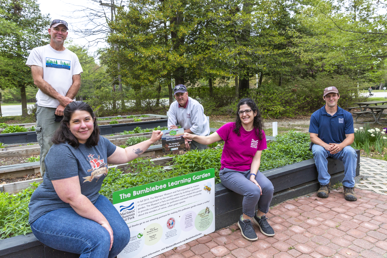 Five museum staff members accept the 2021 Virginia Green Travel Leader award for the Bumblebee Learning Garden. 