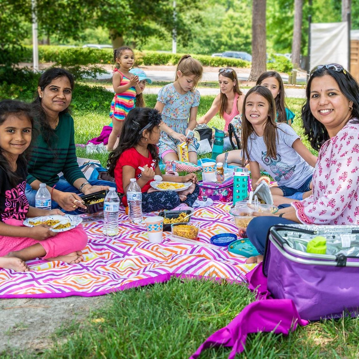 large family enjoys a picnic in Mariner's Park.