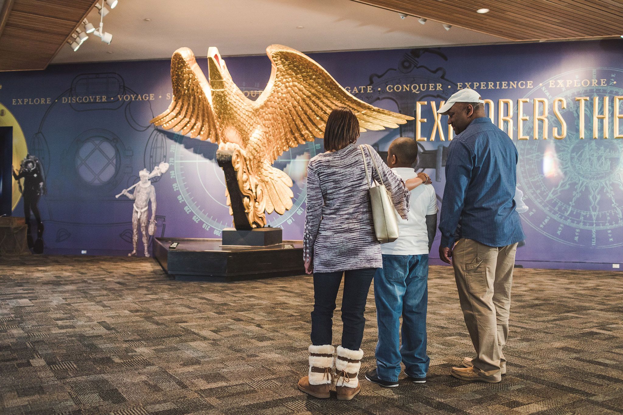 Family looking at the USS Lancaster eagle in the Main Lobby.