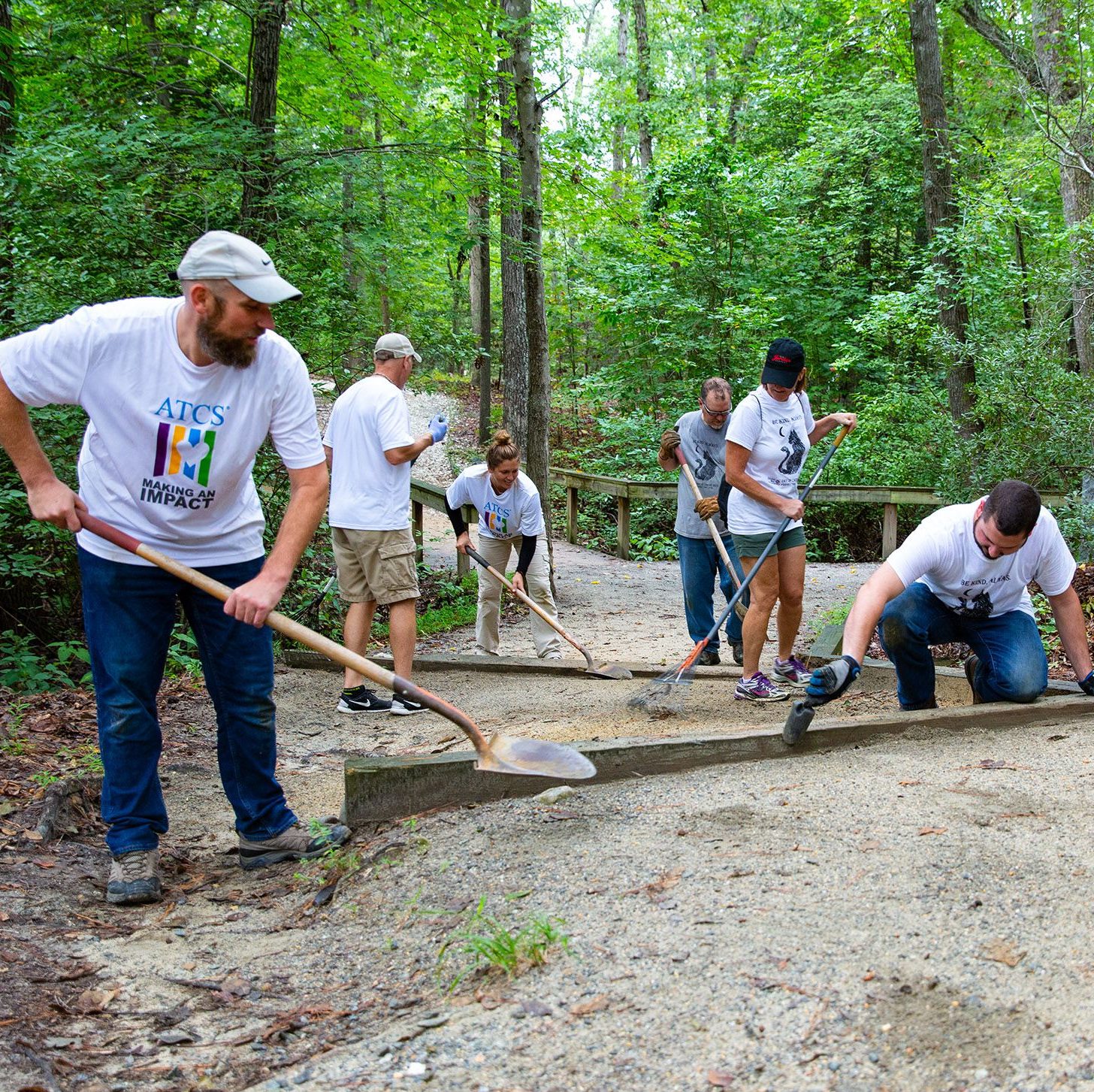 Group of people working on trail with shovels