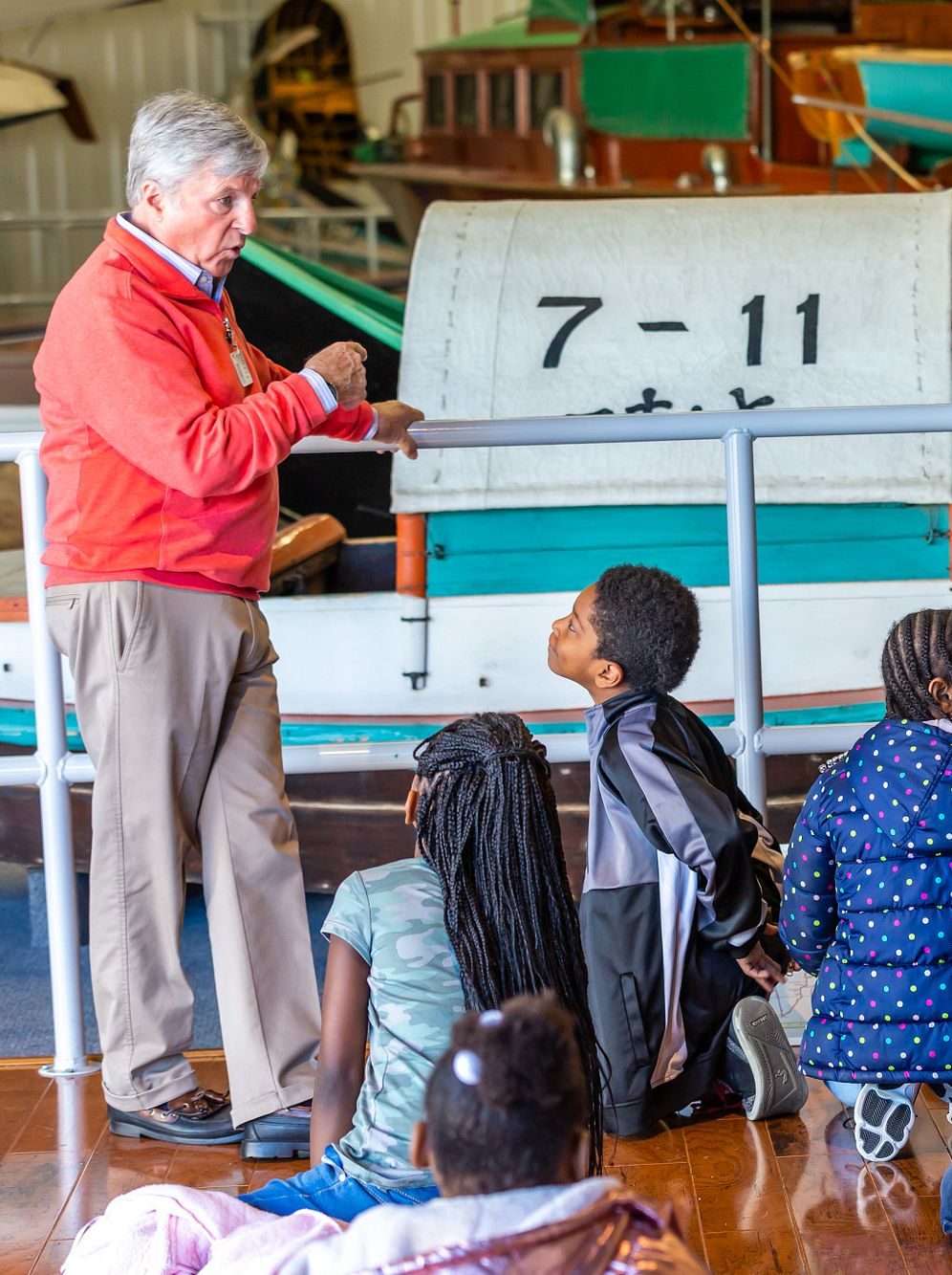 Docent giving students a tour in the International Small Craft Center.