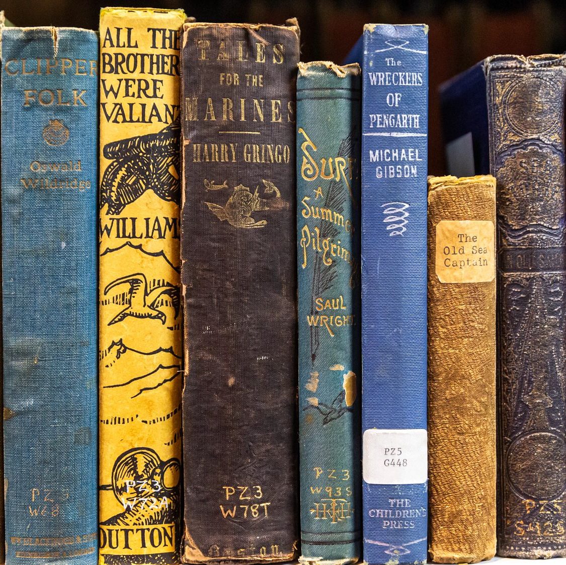 Rare books stacked in a row.