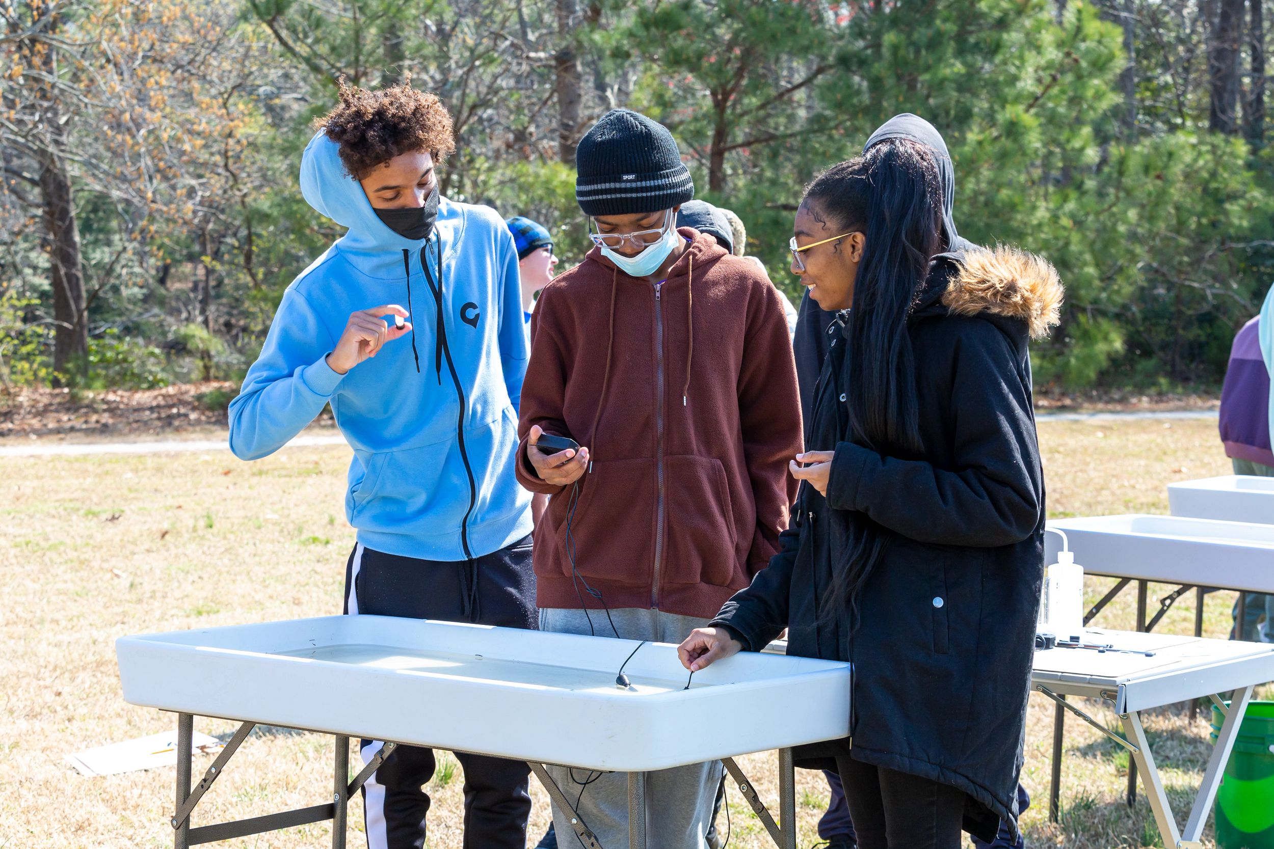 Students take temperature of water sample from Mariners' Lake.