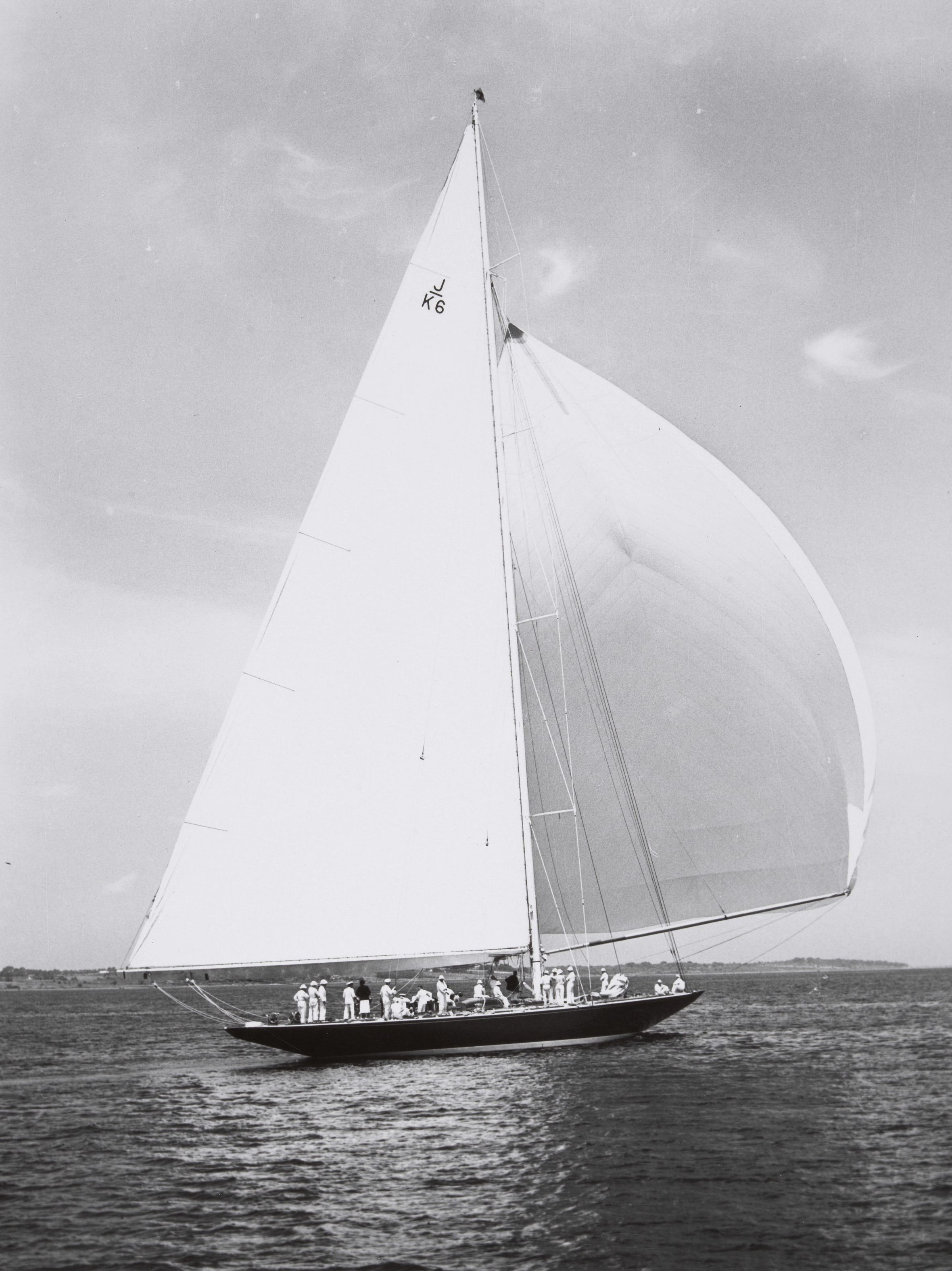 Black and white image of a large sail boat at sea.