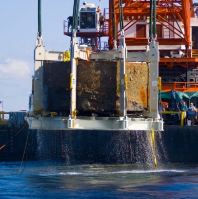 USS Monitor Turret rising from ocean.