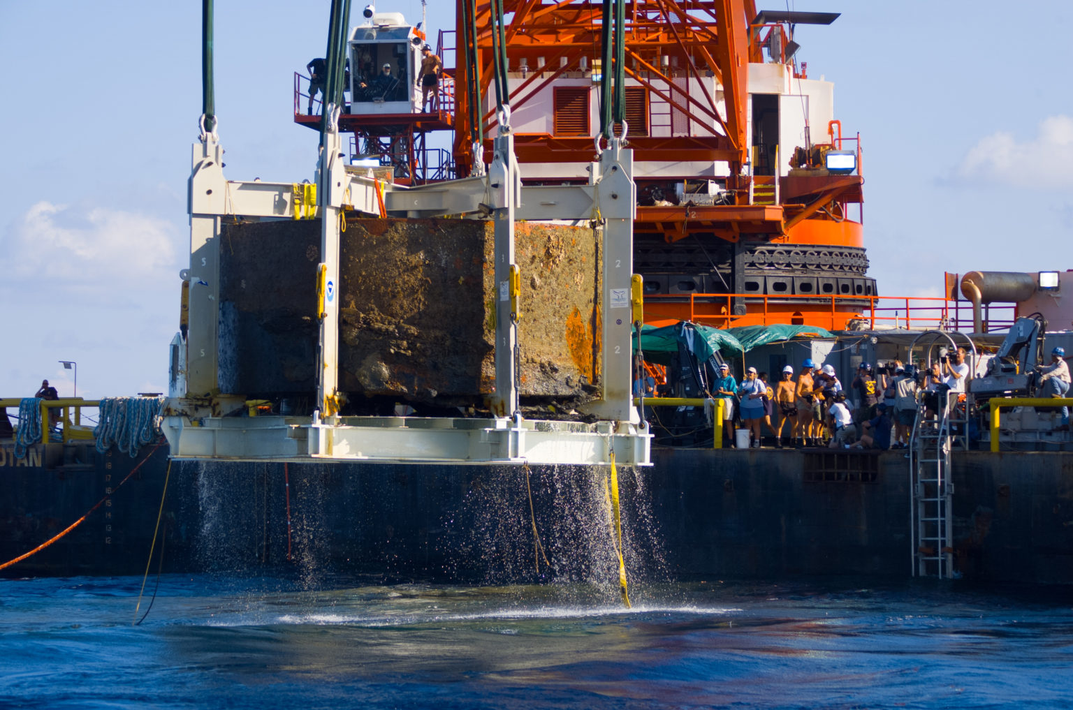 USS Monitor Turret rising from ocean.