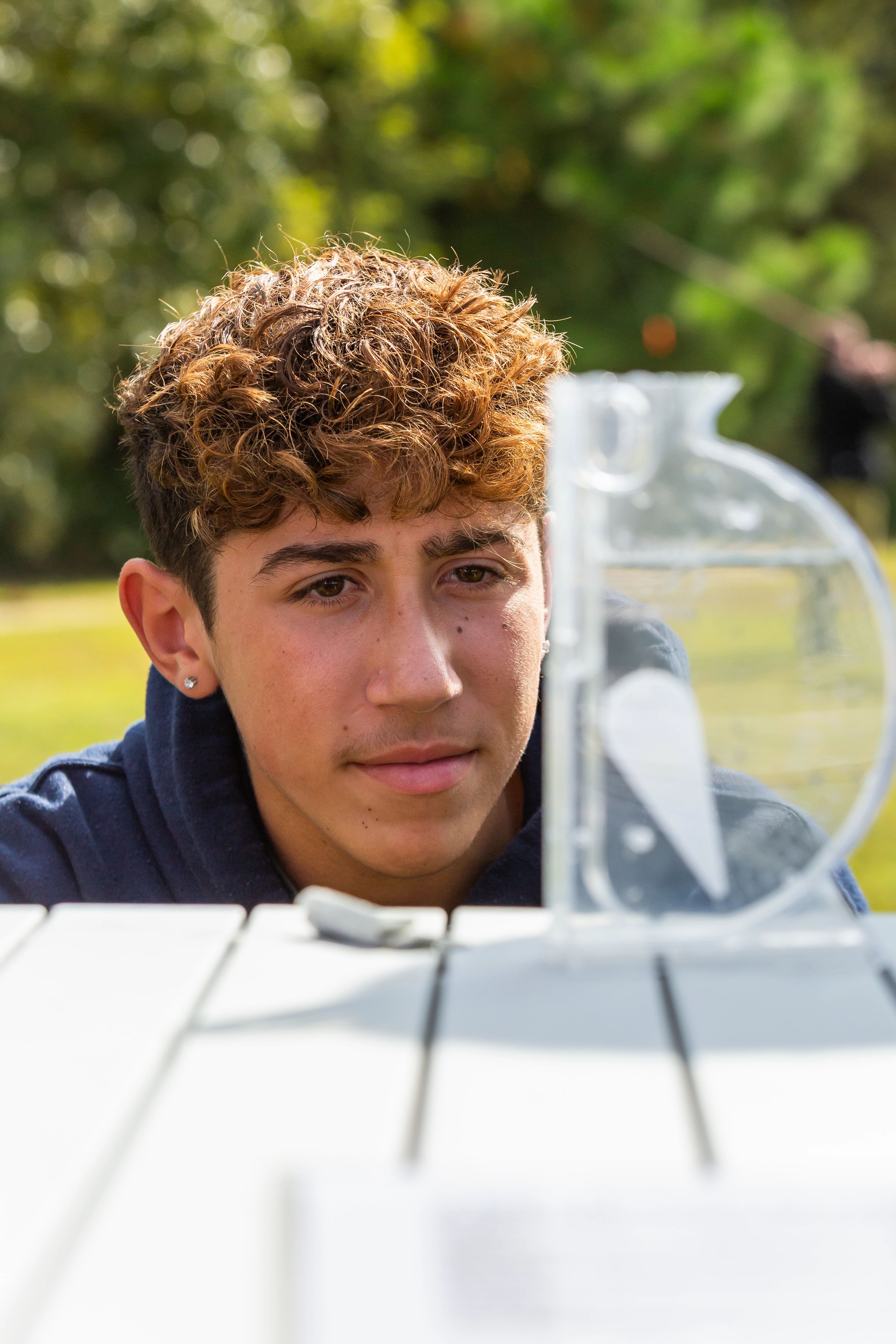 A Menchville High School student measures Mariners' Lake's water quality.