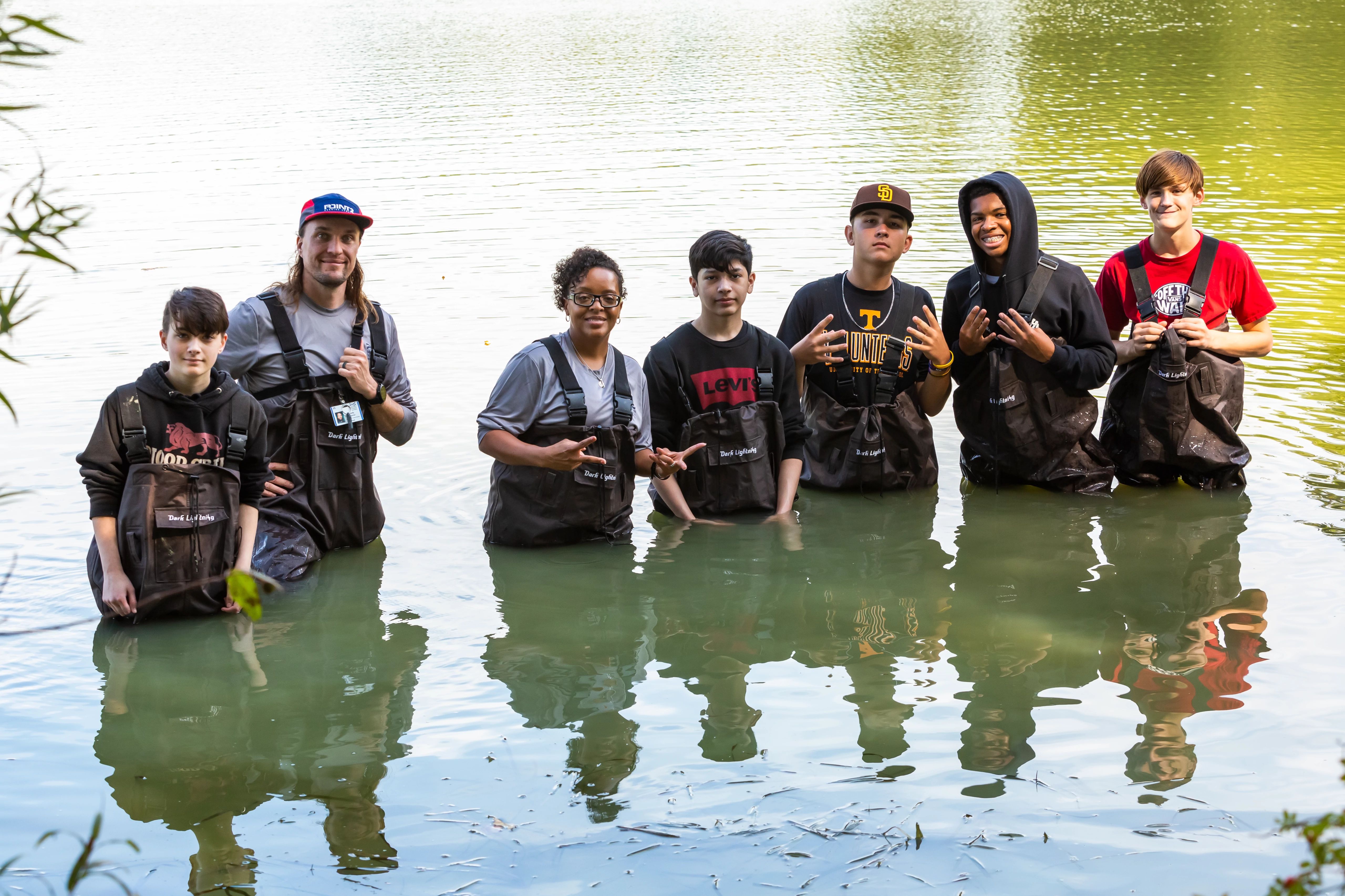 Students from Menchville High School wearing their waders in Mariners' Lake.