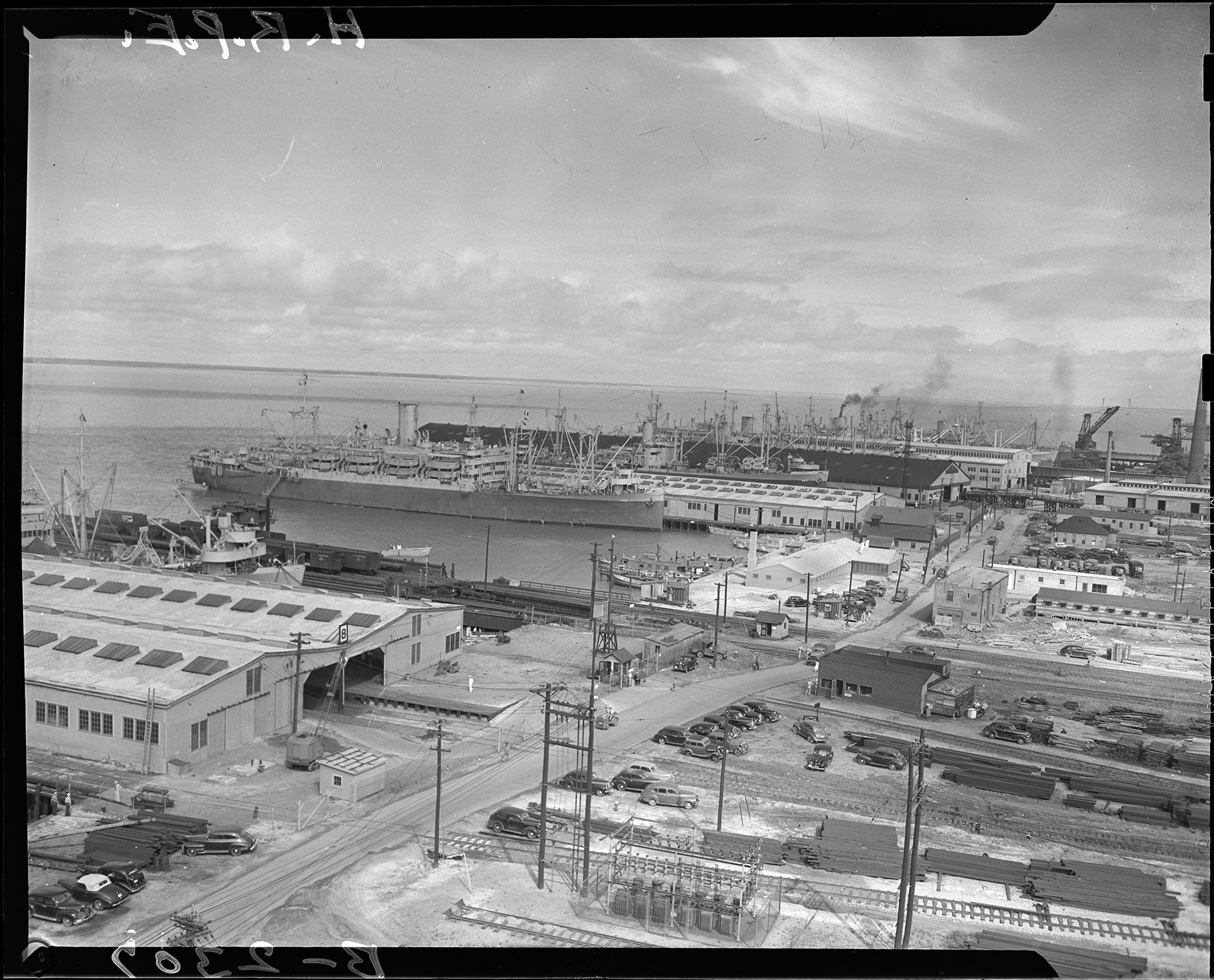 Overhead view of ships docked in piers at Hampton Roads Port of Embarkation.