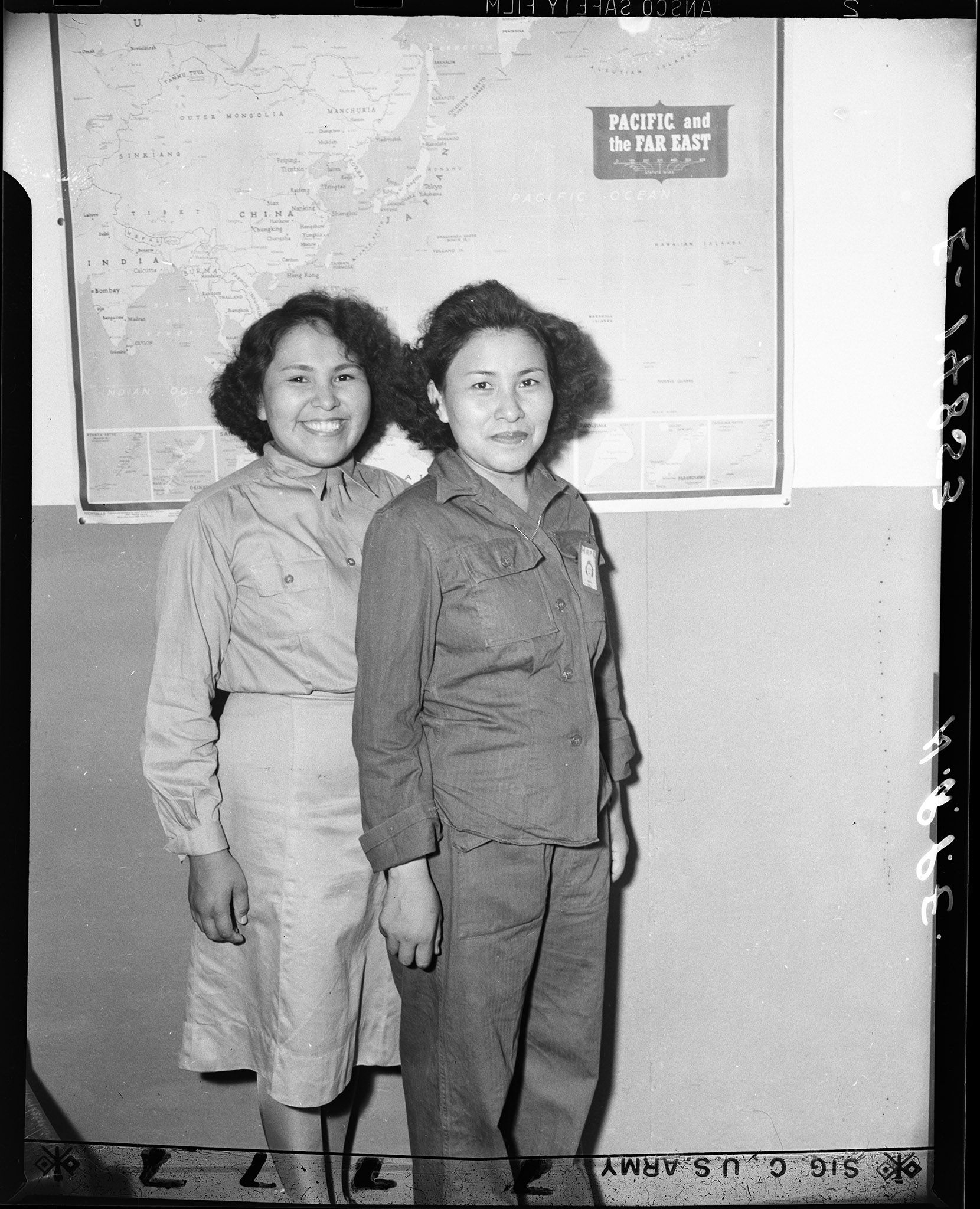 Left to right: Sisters serving in the Women's Army Corps, Pvt. Lupe Mirabel and Pvt. Florence Lee, photographed by the US Army Signal Corps.