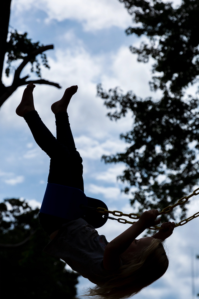 Silhouette of young girl swinging at Lil’ Mariners’ Play Zone.