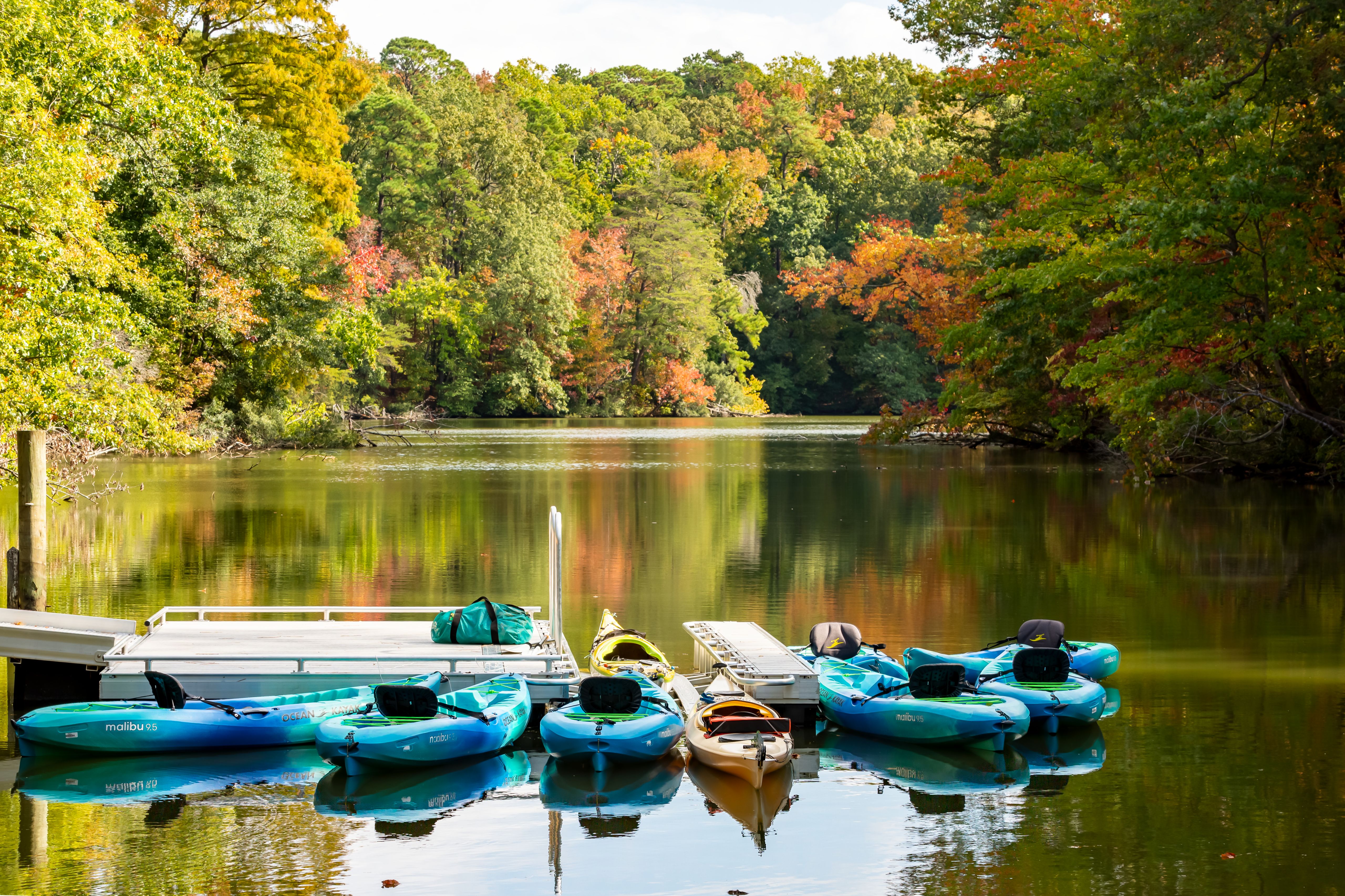 These kayaks on Mariners’ Lake are considered boats since they are small vessels that travel on the water.