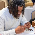 A teacher from Newport News Public High Schools working on preparing native seeds for planting in a B-WET teacher professional development session on native plants.