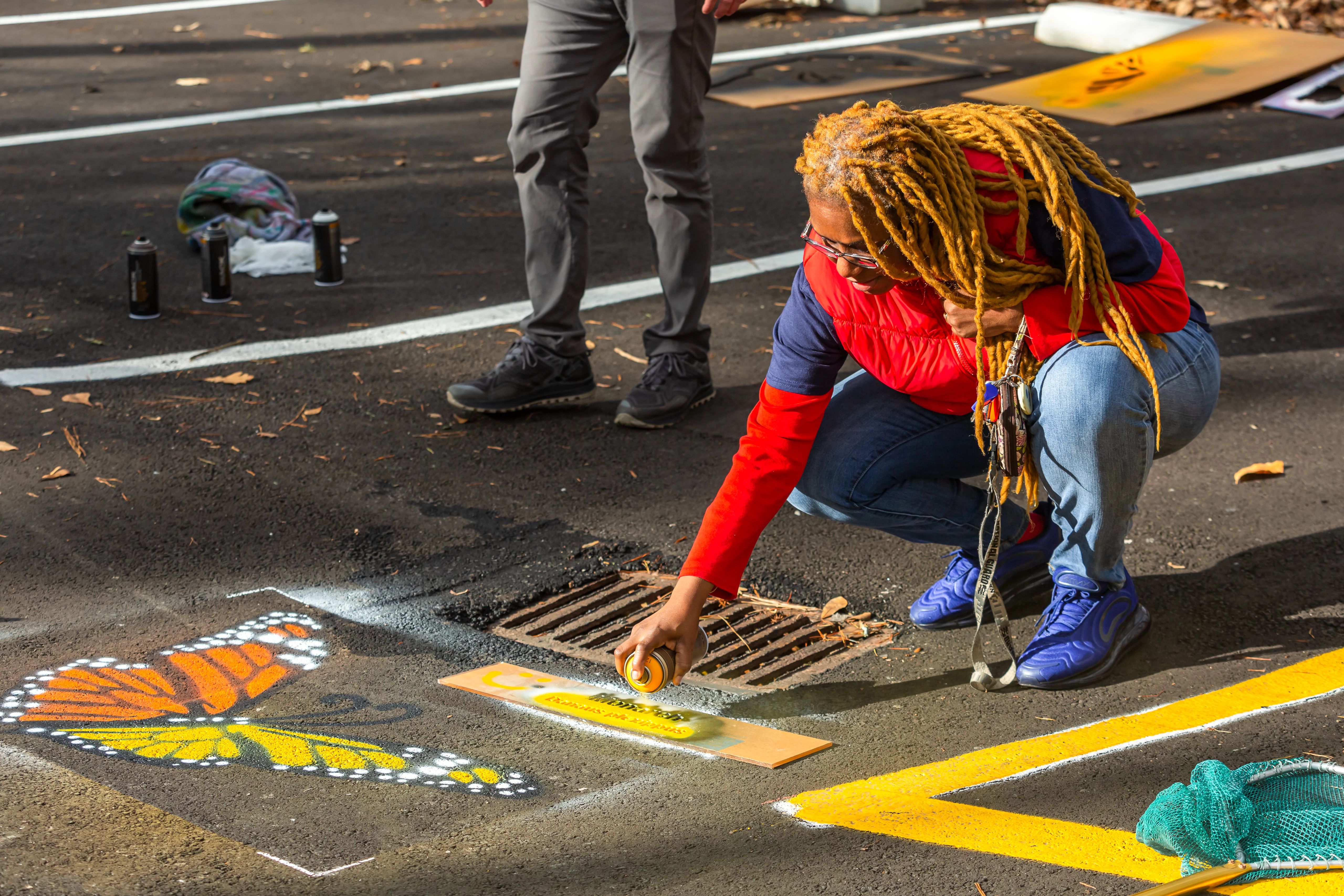 A teacher from Newport News Public High Schools participates in a “Paint Out Pollution” activity.