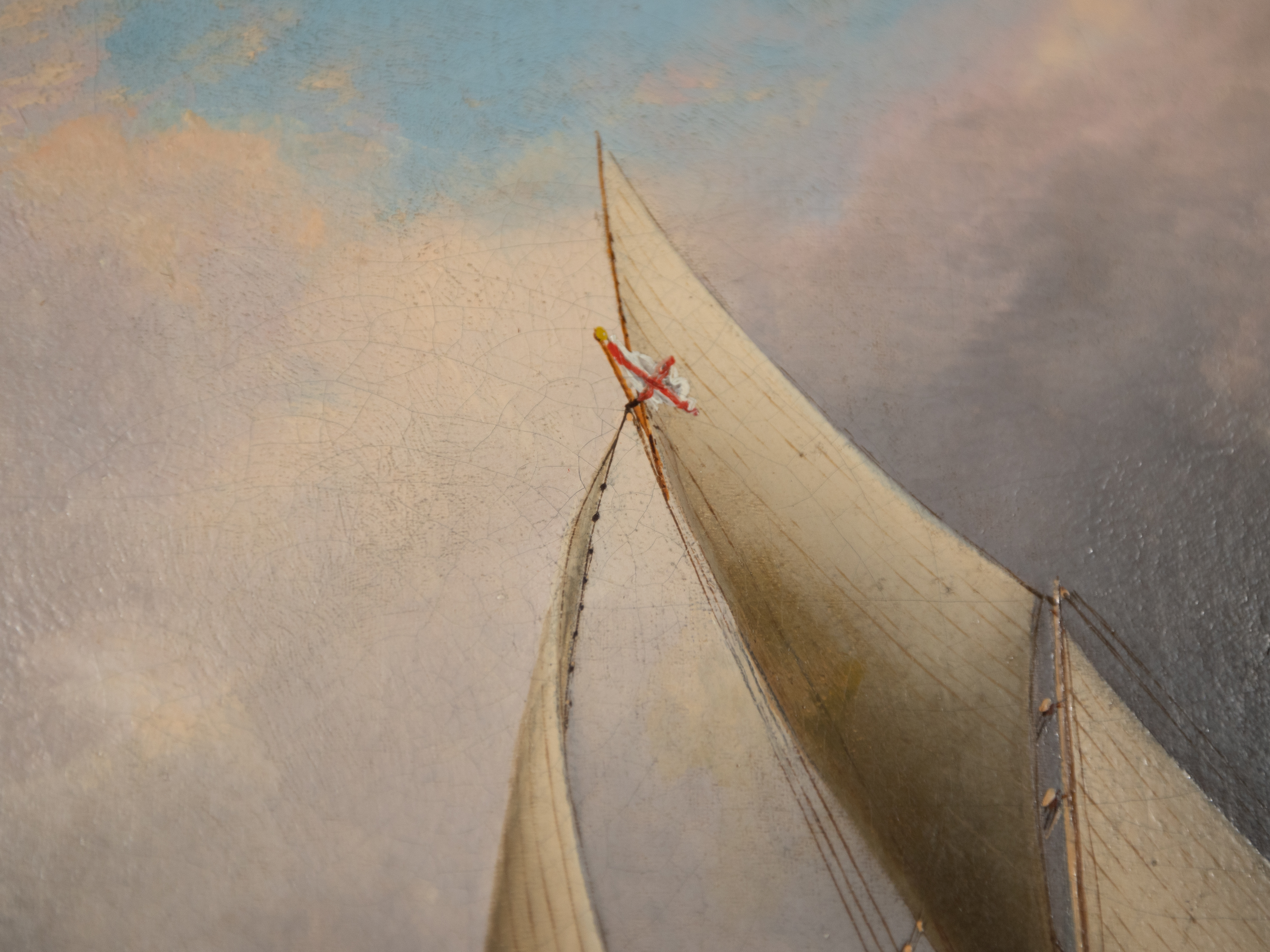 Detail: One of a number of inaccuracies included in the painting. According to our new catalog notes, the private signal depicted on Genesta's mast is incorrect - looking at a number of paintings of the 5th and 6th Cup matches, Buttersworth flips between pennant and rectangular flags and red crosses and saltires.