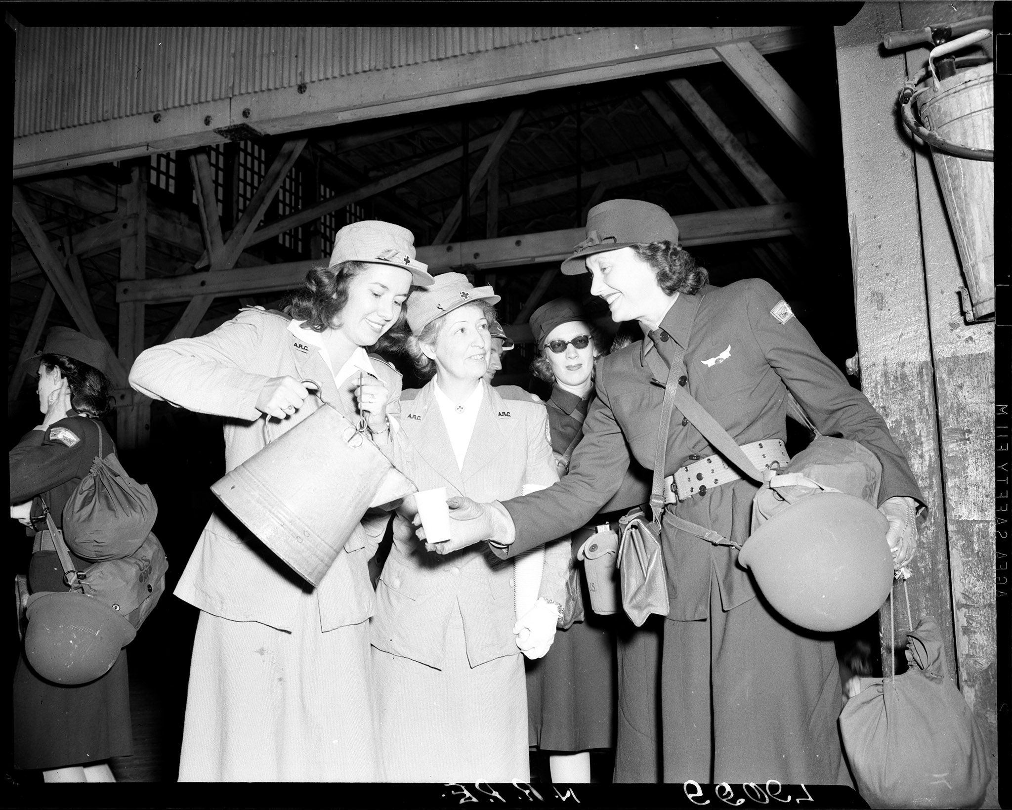 Katharine Cornell, right, is poured a glass of lemonade by a Red Cross volunteer.