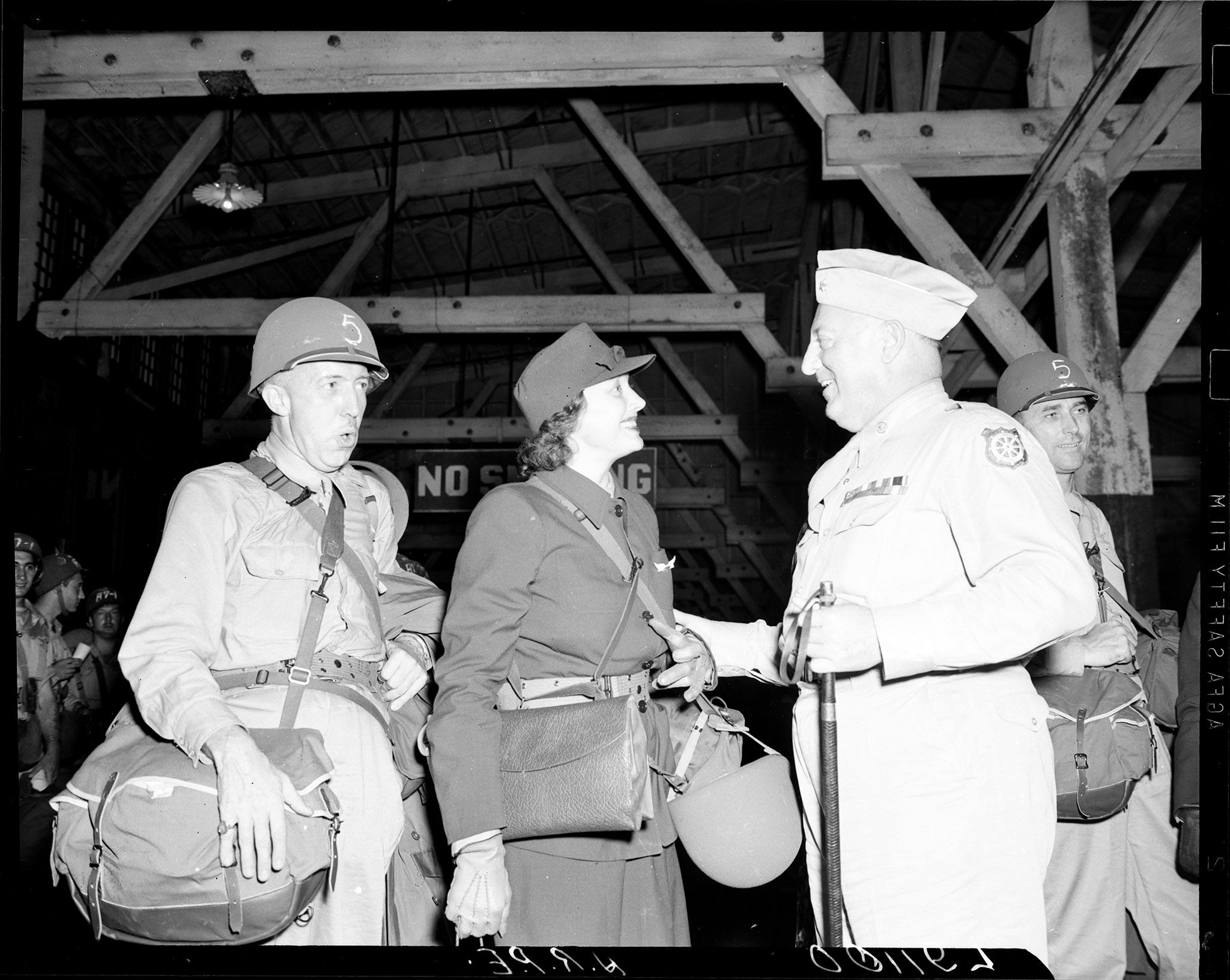 Katharine Cornell shakes hands with General Kilpatrick at the Hampton Roads Port of Embarkation.