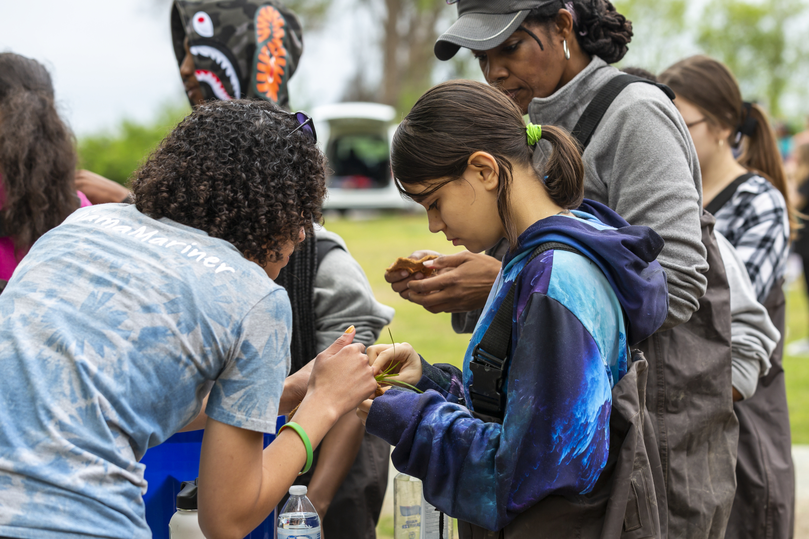 Environmental Science Educator, Shantelle Landry, assists Warwick High School students at the planting station on field trips to The Mariners’ Museum and Park.