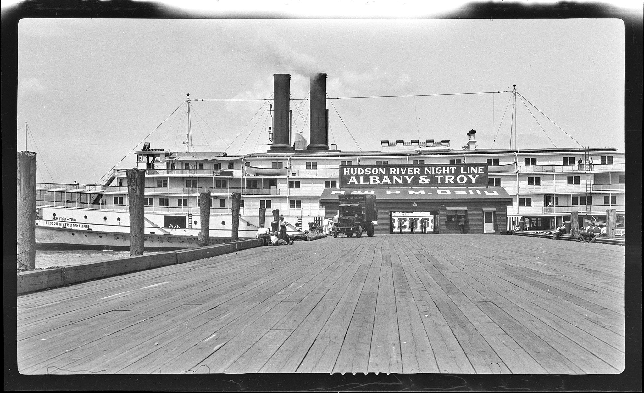 Rensselaer at the Pier. Sign reads “Hudson River Night Line, Albany & Troy, 6:40 P.M. Daily”.