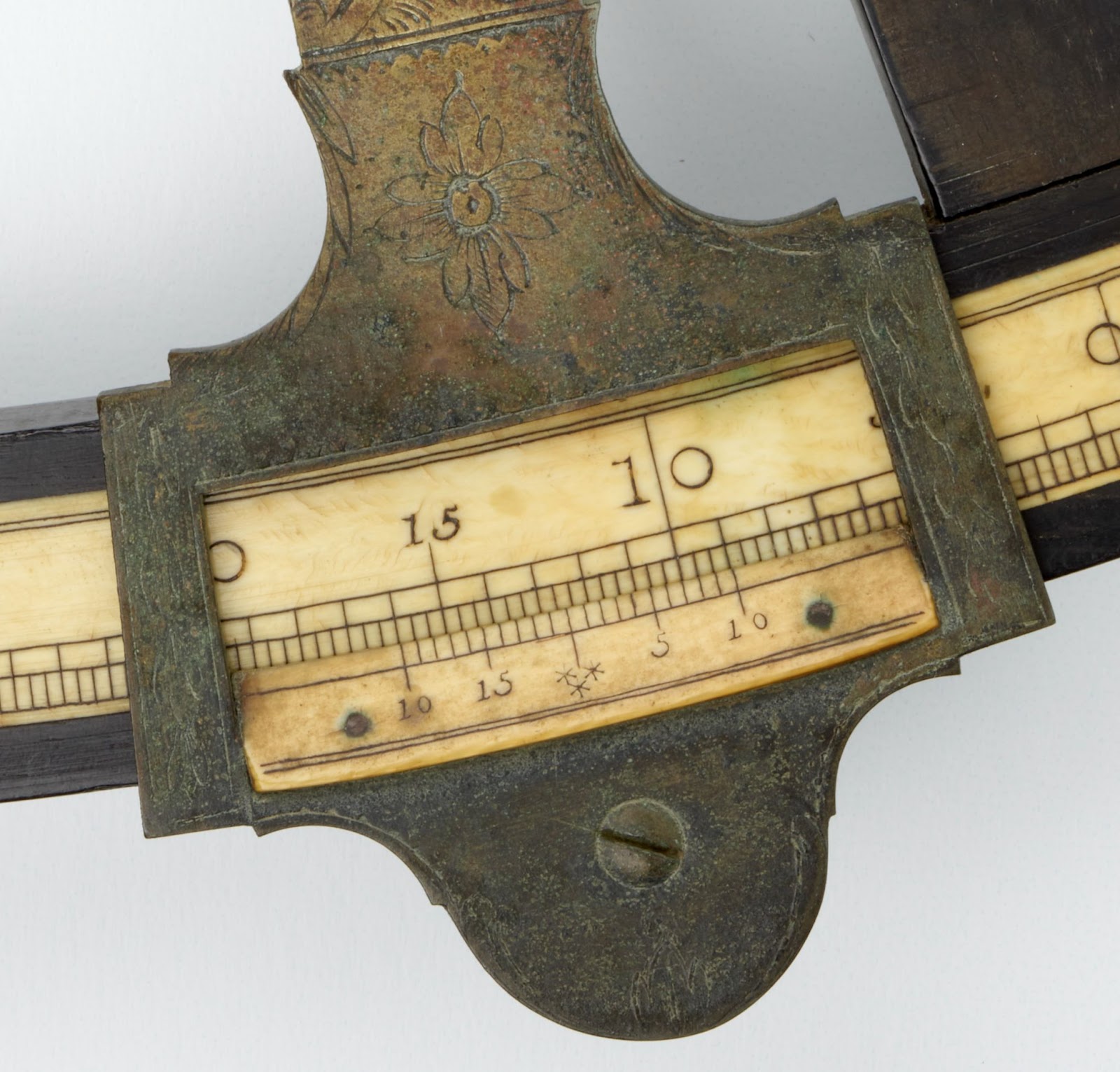 Although it's difficult to see in the image, the engravings at the base of the index arm of NQ57 are very similar to those on 1998.0039.000099.
