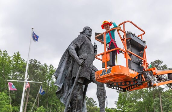 Image of Marimar on an orange lift in front of Leifr Eiriksson, Son of Iceland.