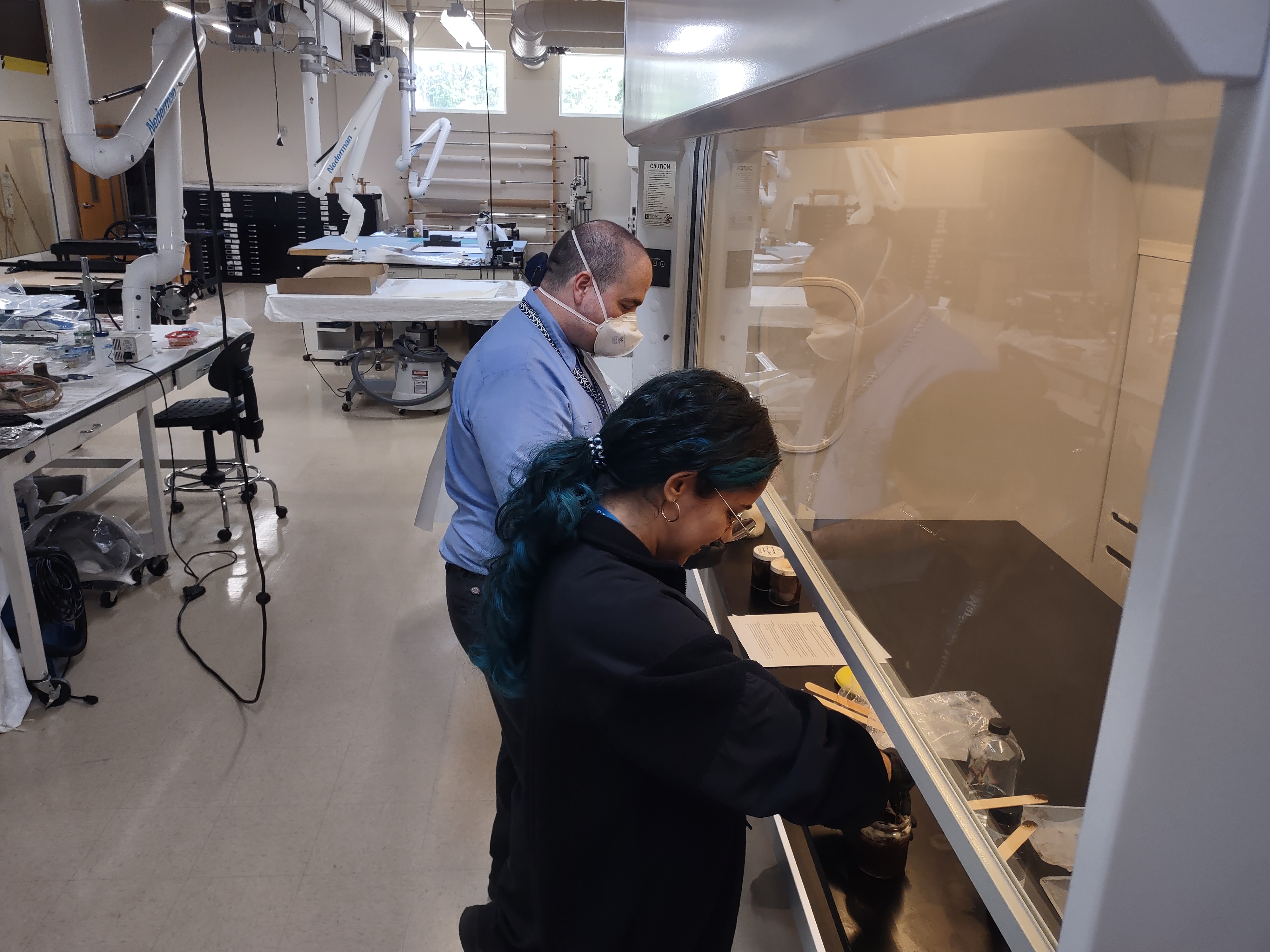 Image of Senior Objects Conservator Erik Farrell and Conservation intern Marimar Bracero Rodríguez preparing the colored wax at the Clean Lab.