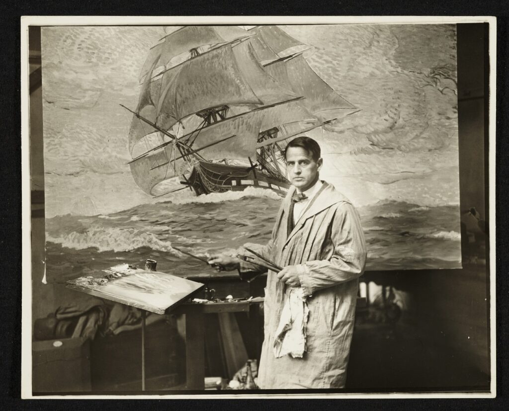 Clifford Warren Ashley stands in front of a large canvas with a ship in choppy swells