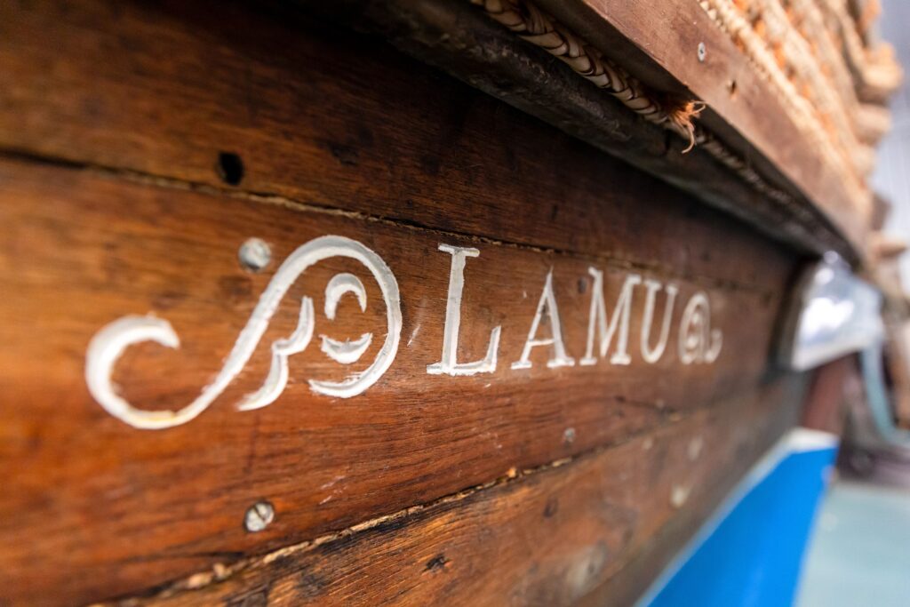 side of boat - words lamu engraved on it