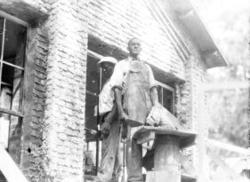 Museum employees laying bricks,