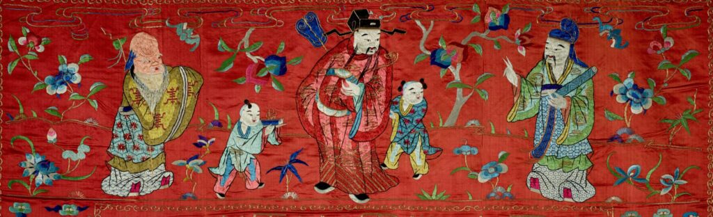 Gods and flowers form a scene along the top of the tapestry.