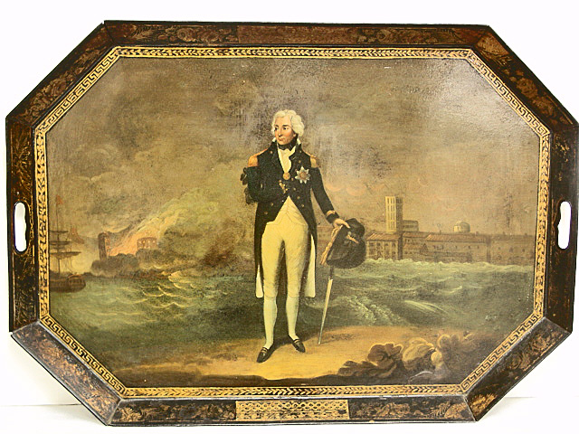 A bronze-colored antique tray with handles. On the bottom of the tray, an image of a uniformed man with a sword stands on the beach in front of water and a town covered in billows of smoke.