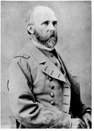Balding man poses for a portrait wearing a uniform