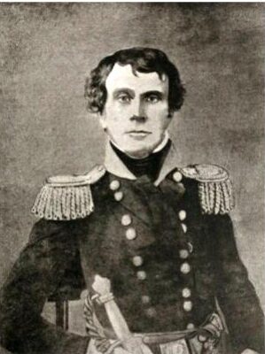 A man sits for a portrait in military uniform