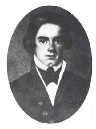 A man sits for a portrait wearing a formal uniform