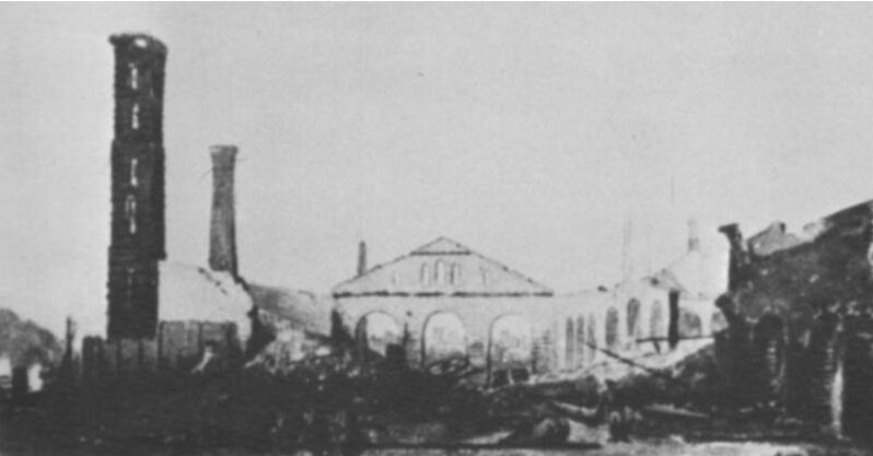 Black and white image of the ruins of a building.