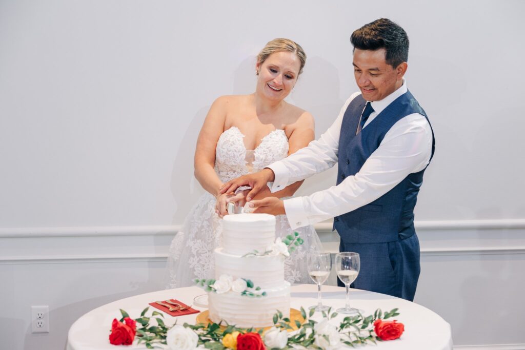 Bride and groom cutting the wedding cake.