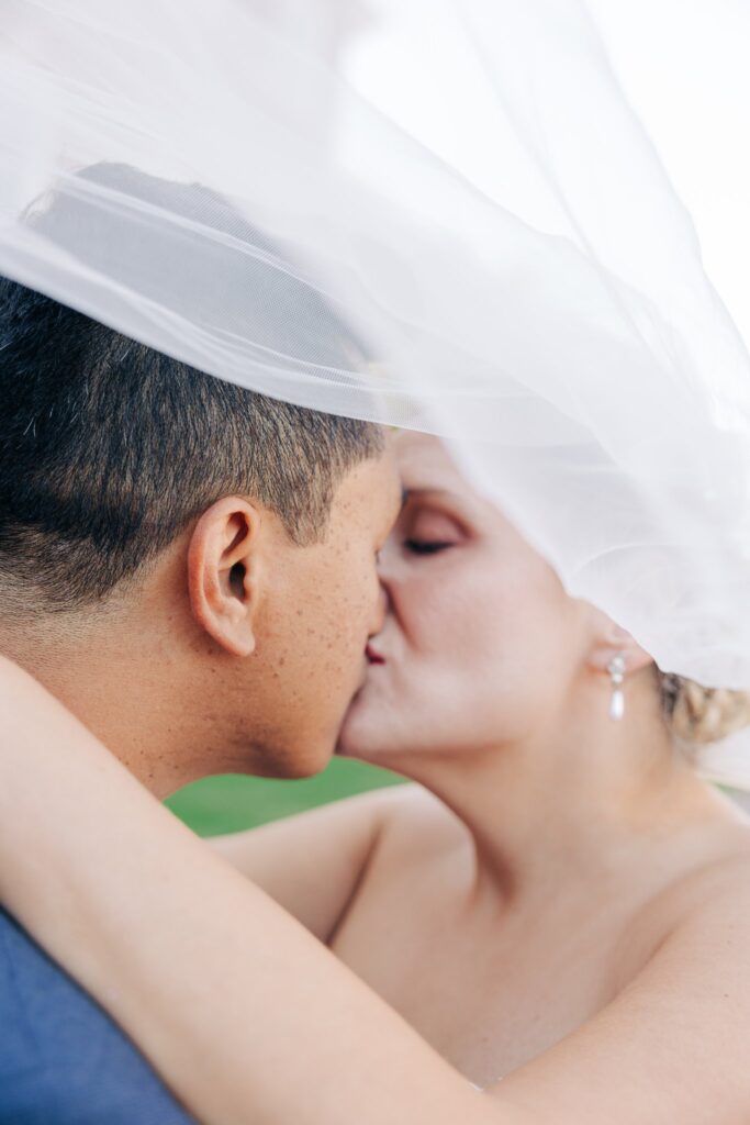 Close up of bride and groom kissing.
