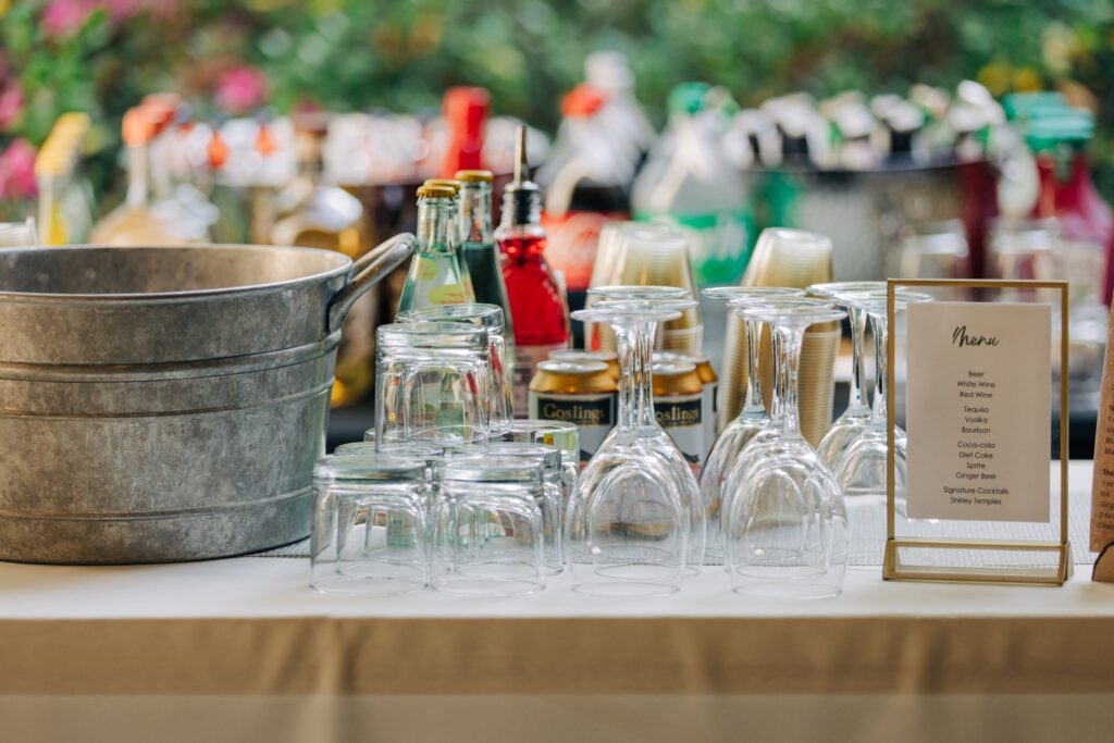 Bar table with wine and beverage glasses next to the menu.