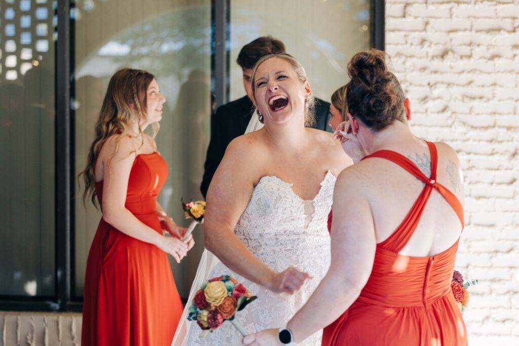 Bride laughing with one of the bridesmaid.