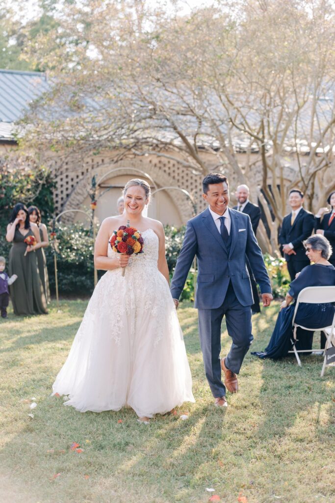 Bride and groom walking away from the altar after saying "I do".