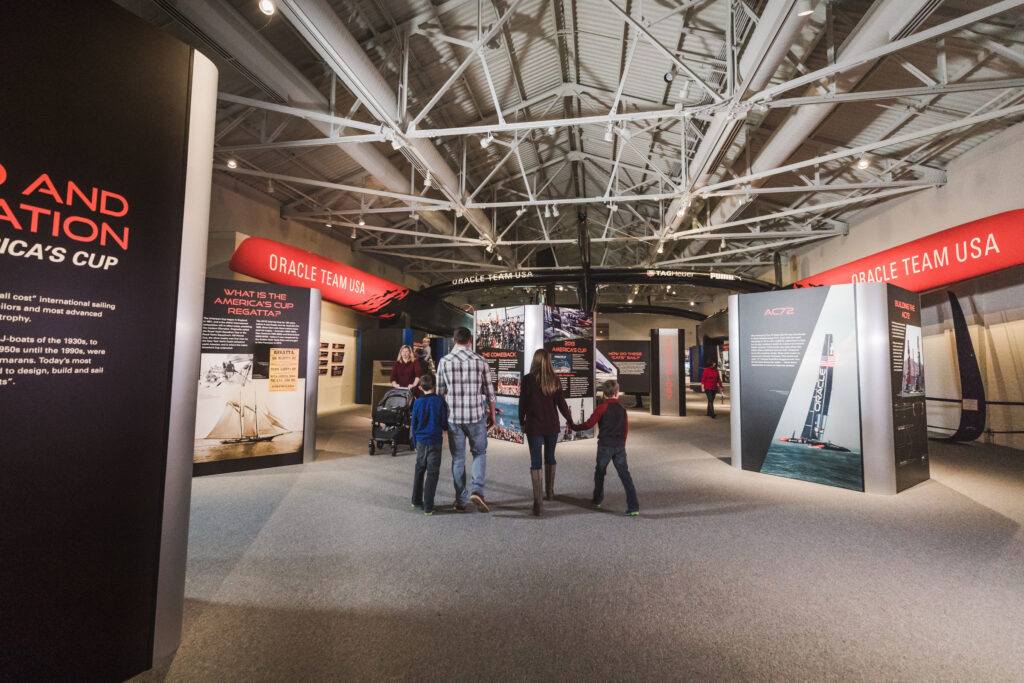 Image of people walking through The Speed and Innovation in The America's Cup gallery.